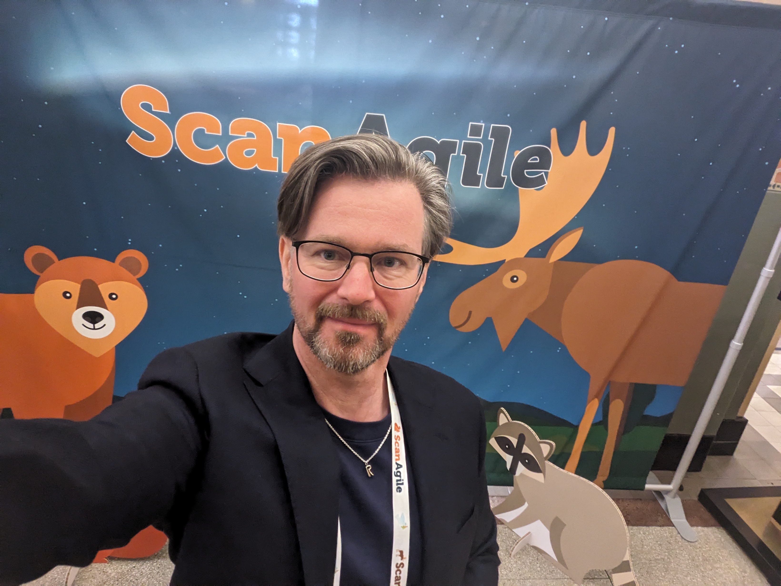 Jimmy Sjölund taking a selfie in front of a ScanAgile banner.